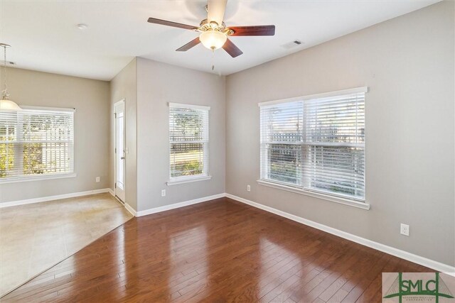 empty room featuring ceiling fan and dark wood-type flooring