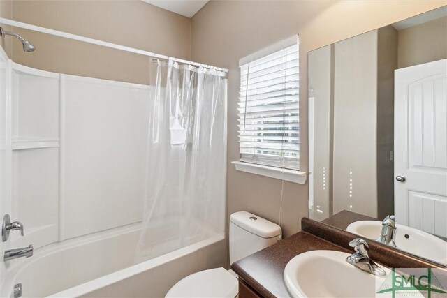 full bathroom featuring shower / tub combo with curtain, vanity, and toilet