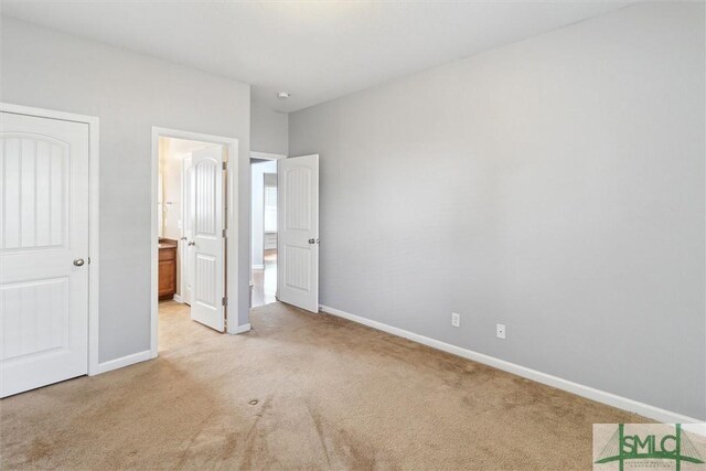 unfurnished bedroom featuring light carpet