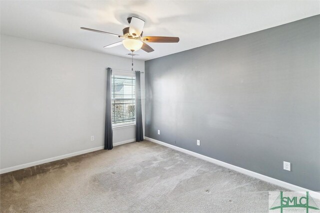 spare room with light colored carpet and ceiling fan