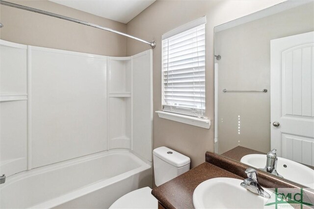 full bathroom with bathtub / shower combination, vanity, and toilet