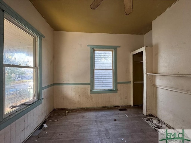 unfurnished bedroom with multiple windows and ceiling fan