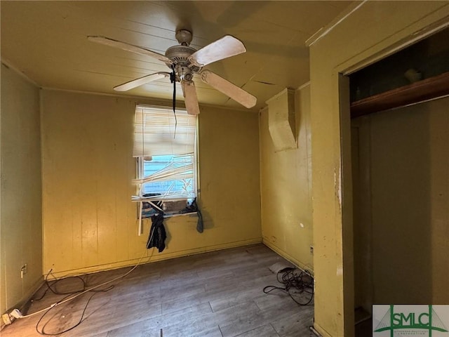 interior space featuring wood-type flooring and ceiling fan