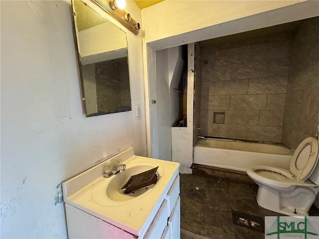 full bathroom featuring vanity, toilet, and tiled shower / bath