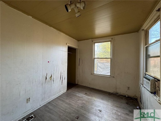 unfurnished bedroom featuring hardwood / wood-style floors and wood ceiling