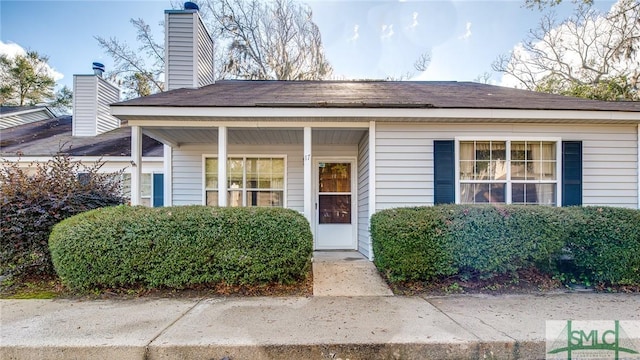 view of exterior entry featuring a porch