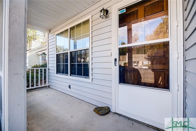 view of exterior entry with a porch