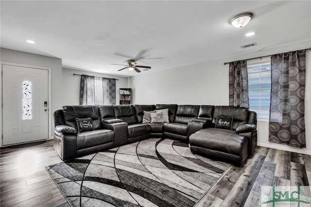 living room with hardwood / wood-style flooring and ceiling fan