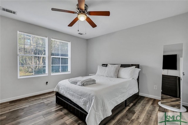 bedroom with ceiling fan and wood-type flooring