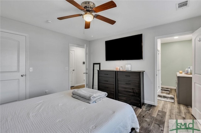 bedroom with wood-type flooring and ceiling fan