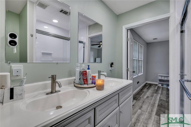 bathroom with hardwood / wood-style floors, vanity, and ceiling fan