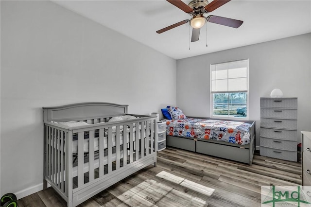 bedroom with hardwood / wood-style flooring and ceiling fan