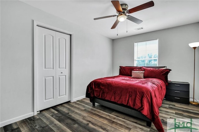 bedroom with ceiling fan, dark hardwood / wood-style flooring, and a closet