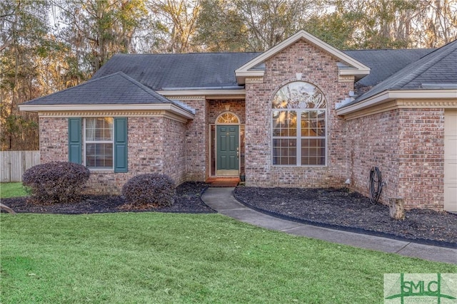 view of front of house with a front yard and a garage