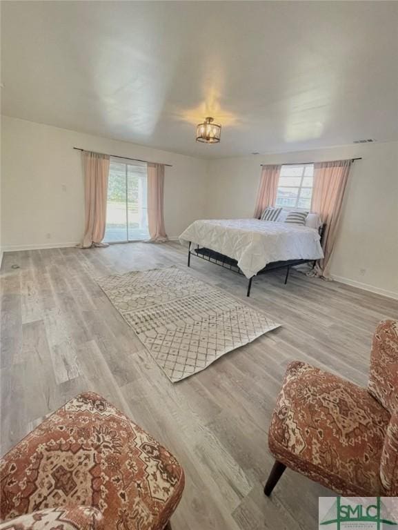 bedroom featuring light wood-type flooring and multiple windows