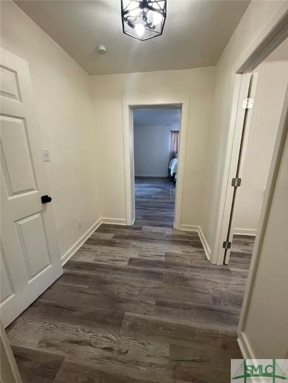 hallway featuring dark hardwood / wood-style flooring