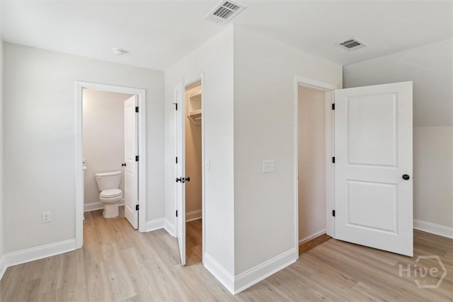 130 N Skinner Ave, Pooler, GA 31322 - unfurnished bedroom with light wood finished floors, a spacious closet, baseboards, and ensuite bathroom