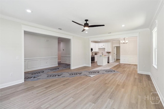 130 N Skinner Ave, Pooler, GA 31322 - unfurnished living room featuring a decorative wall, ceiling fan, ornamental molding, light wood finished floors, and a chandelier