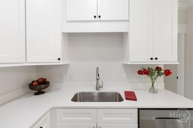 130 N Skinner Ave, Pooler, GA 31322 - kitchen with stainless steel dishwasher, a sink, white cabinetry, and light countertops