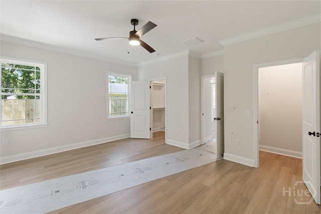130 N Skinner Ave, Pooler, GA 31322 - unfurnished bedroom with a spacious closet, light wood-style flooring, ornamental molding, a closet, and baseboards