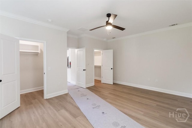130 N Skinner Ave, Pooler, GA 31322 - unfurnished bedroom featuring a spacious closet, light wood-type flooring, crown molding, a closet, and baseboards