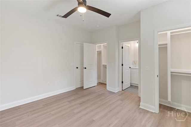 130 N Skinner Ave, Pooler, GA 31322 - unfurnished bedroom with light wood finished floors, baseboards, ensuite bathroom, ceiling fan, and a walk in closet