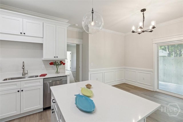 130 N Skinner Ave, Pooler, GA 31322 - kitchen featuring dishwasher, a sink, a chandelier, light countertops, and a wainscoted wall