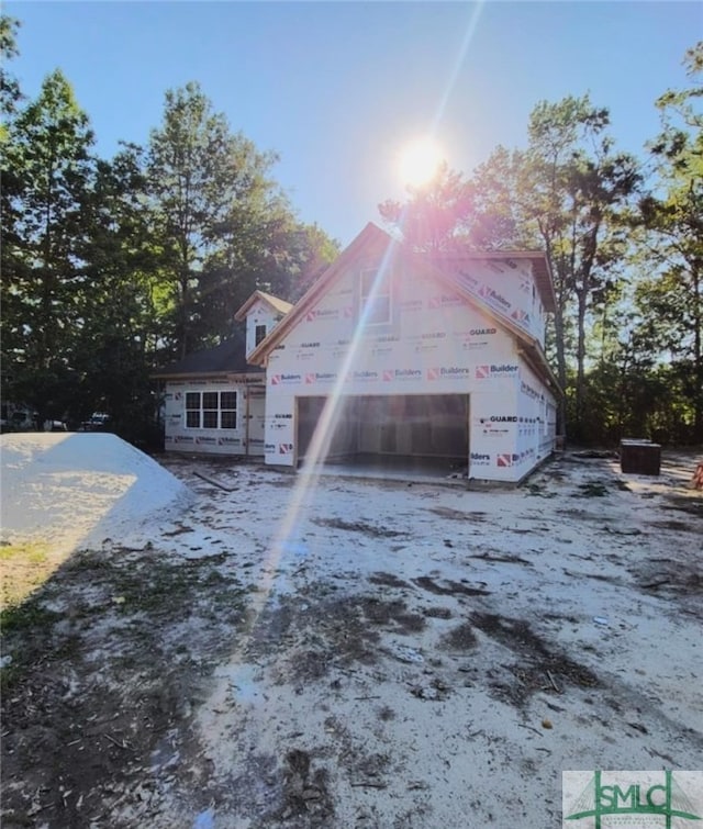 view of side of home featuring a garage