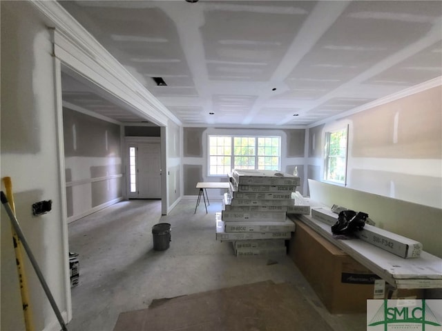 corridor with healthy amount of natural light and crown molding