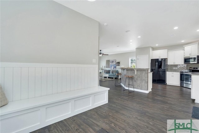 interior space featuring ceiling fan and dark wood-type flooring