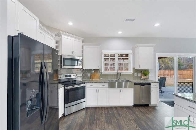 kitchen featuring appliances with stainless steel finishes, white cabinetry, and sink