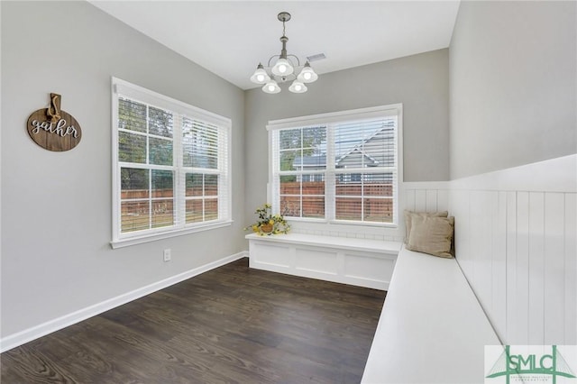 interior space with a chandelier, dark hardwood / wood-style floors, and plenty of natural light