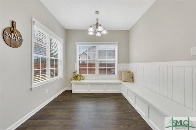 unfurnished room featuring dark hardwood / wood-style flooring and a notable chandelier