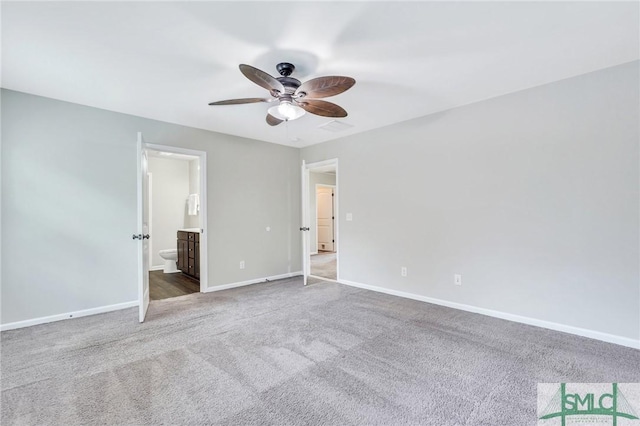 unfurnished bedroom featuring carpet, ceiling fan, and ensuite bath