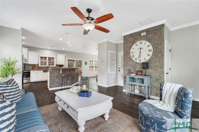 living room with crown molding, ceiling fan, and dark hardwood / wood-style floors