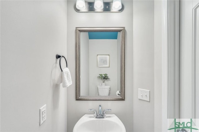 bathroom featuring sink and toilet