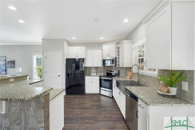 kitchen featuring light stone countertops, white cabinetry, sink, and appliances with stainless steel finishes