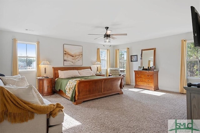 bedroom with ceiling fan and light colored carpet