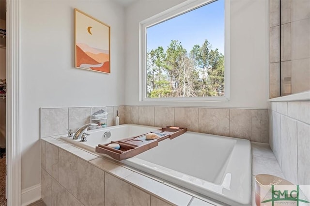 bathroom featuring a relaxing tiled tub