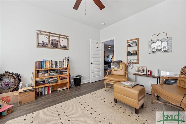 living area with ceiling fan and dark hardwood / wood-style flooring