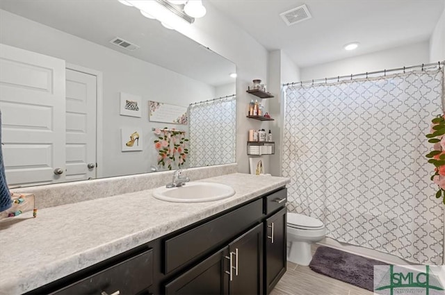 bathroom featuring vanity and toilet