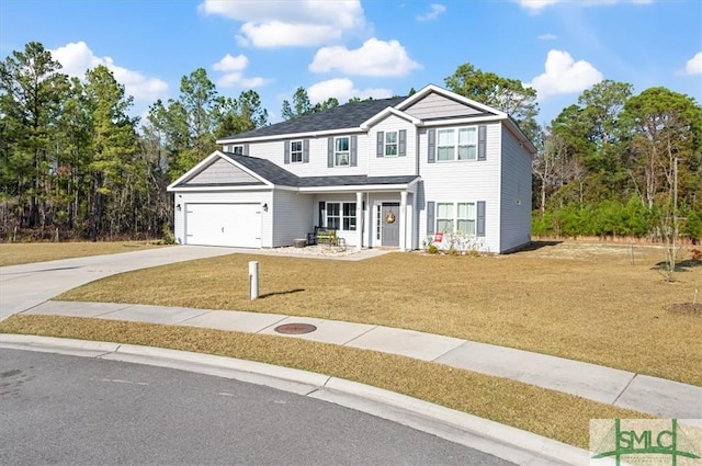 front of property featuring a front lawn and a garage