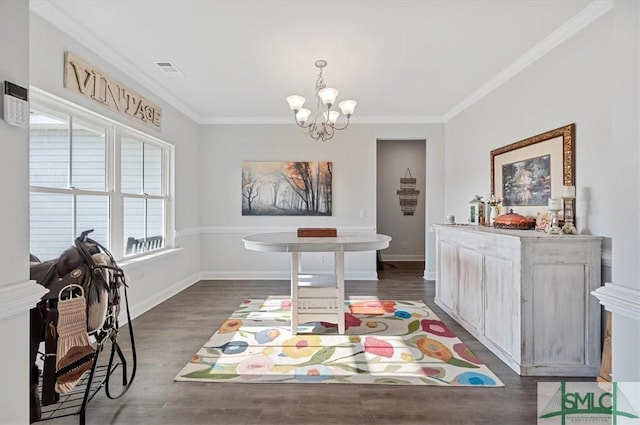 dining room featuring dark hardwood / wood-style floors, ornamental molding, and a chandelier