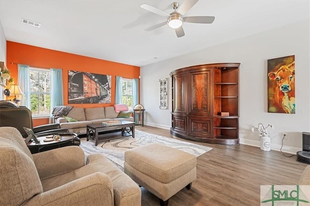 living room featuring ceiling fan and hardwood / wood-style flooring