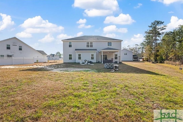 back of house with a lawn