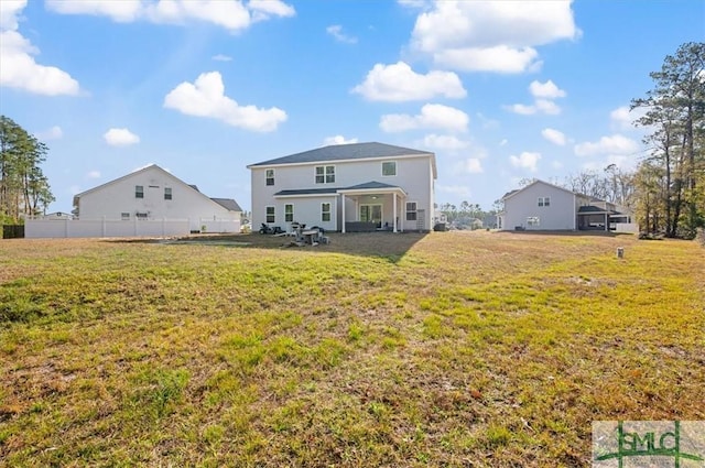 rear view of property with a yard