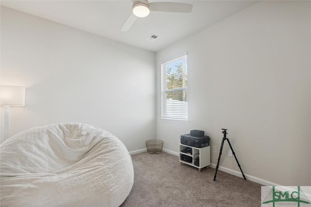 sitting room featuring ceiling fan and light carpet