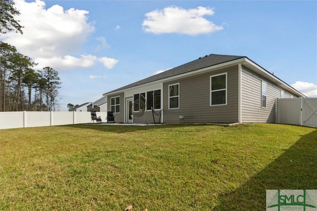 rear view of property featuring a yard