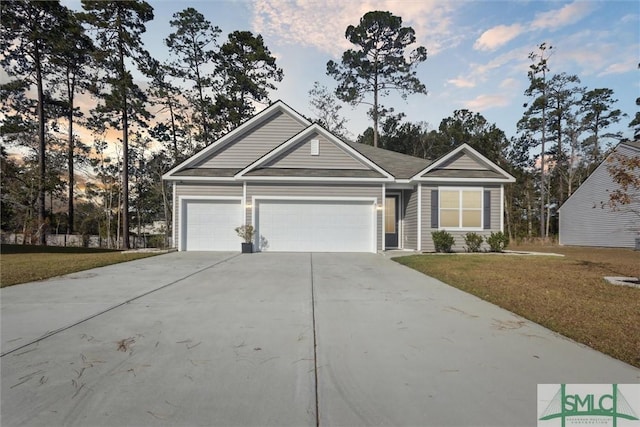 view of front of house featuring a lawn and a garage