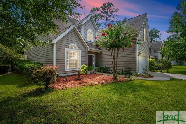 view of front of house with a yard and a garage